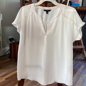 Soft and flowy ivory blouse.